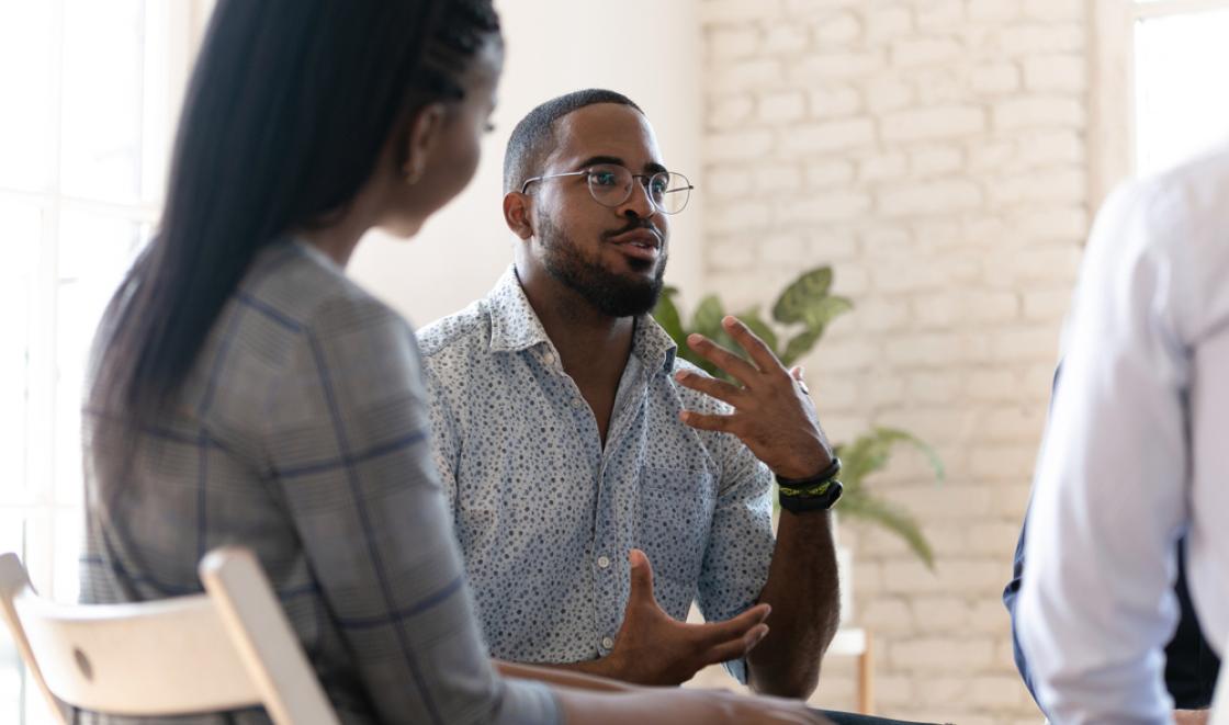 Black man and woman in a group therapy session