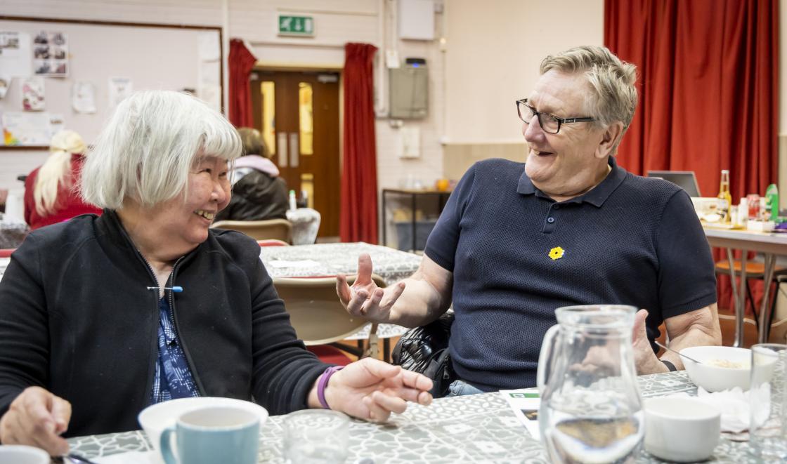 Man and woman at table in day centre