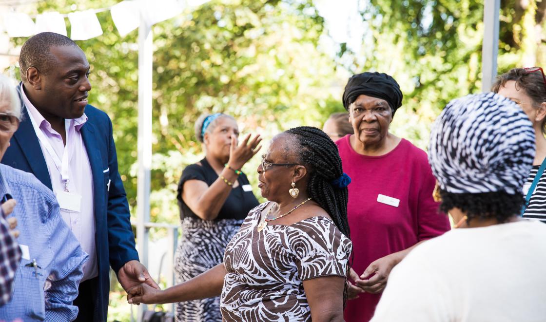 Garden party black woman holding hands with black man