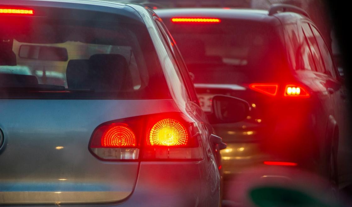 The back of two cars in traffic with their rear lights on